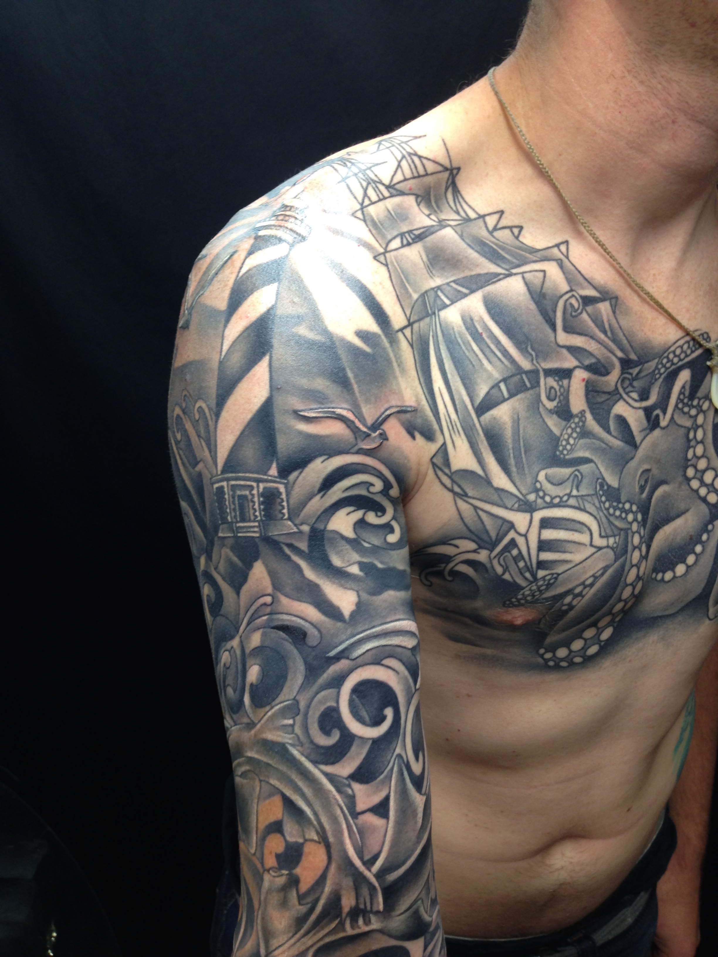 Black & gray lighthouse, ocean, ship & octopus. Tattooing by Brandon G Notch 