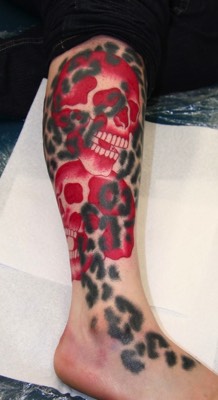  Leopard print and skulls tattoo 