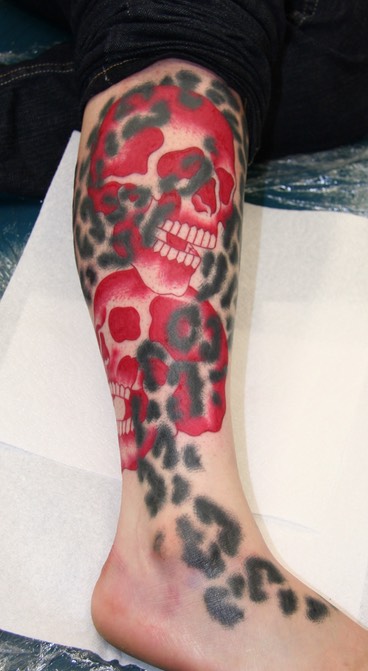  Leopard print and skulls tattoo 