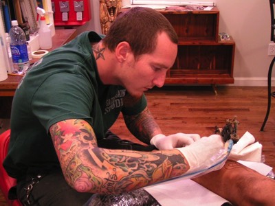  Brandon Notch working his coil tattoo machine 