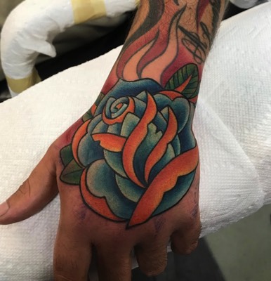  Traditional Rose hand tattoo 